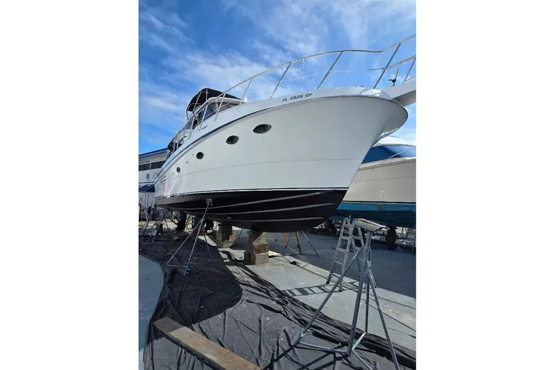 Slide: The Image of 1993 McKinna 48 Pilothouse yacht on dry dock, under clear blue sky. - 103