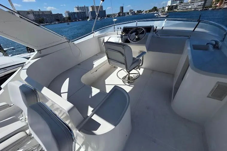 Slide: The Image of 1993 McKinna 48 Pilothouse yacht interior with helm, seating, and waterfront view. - 83