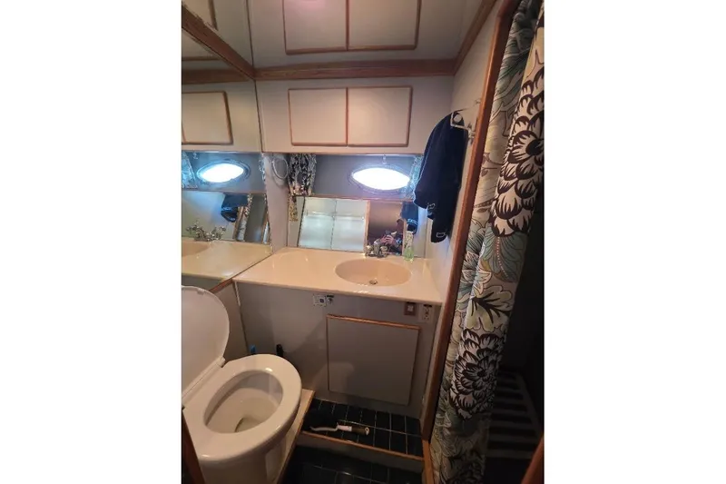 Slide: The Image of Bathroom interior of 1993 McKinna 48 Pilothouse yacht with floral shower curtain. - 48