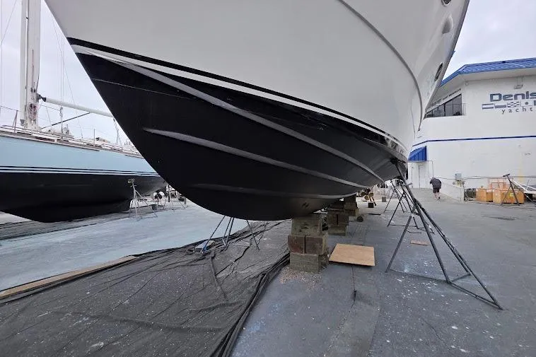 Slide: The Image of 1993 McKinna 48 Pilothouse yacht on dry dock for maintenance at a marina. - 111