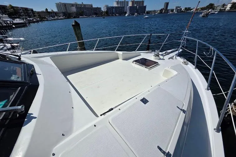 Slide: The Image of 1993 McKinna 48 Pilothouse yacht deck with waterfront cityscape in the background. - 61