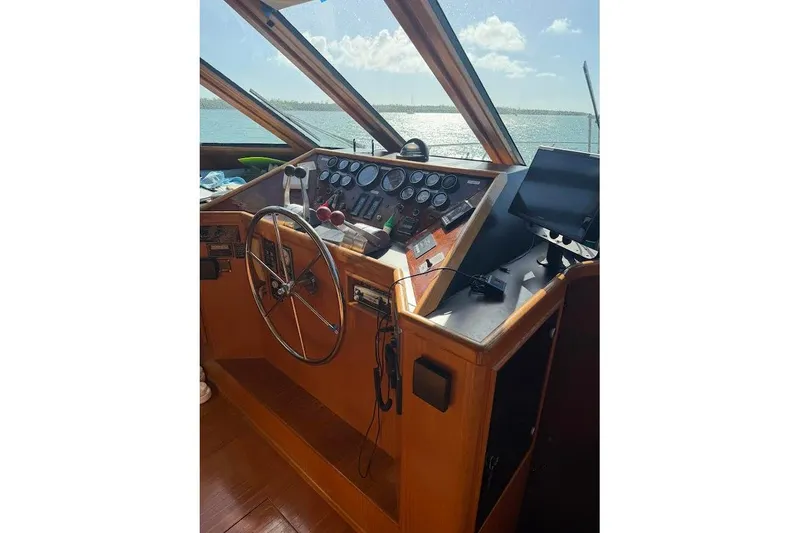 Slide: The Image of Pilothouse interior of 1993 McKinna 48, featuring steering wheel and control panel. - 125
