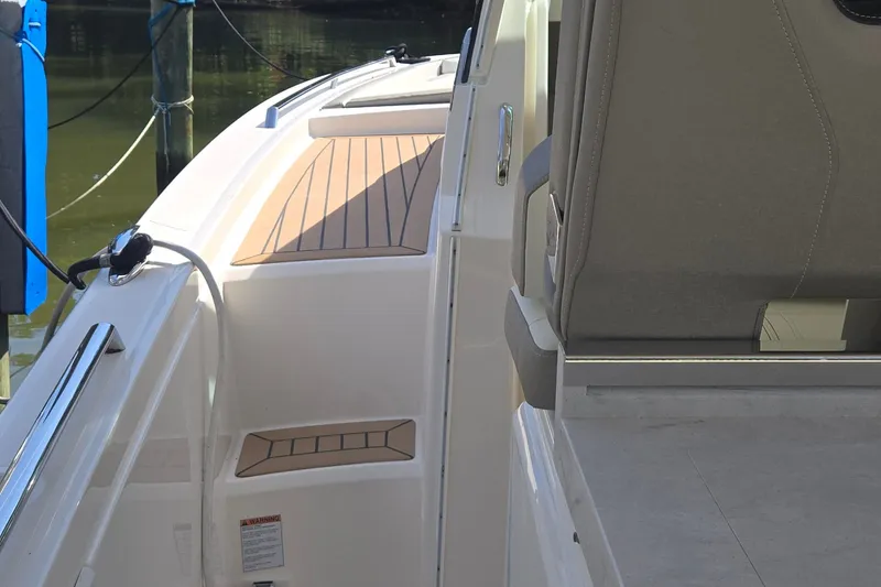 Slide: The Image of 2022 Tiara Yachts 34 LS boat interior with sleek seating and deck design. - 12