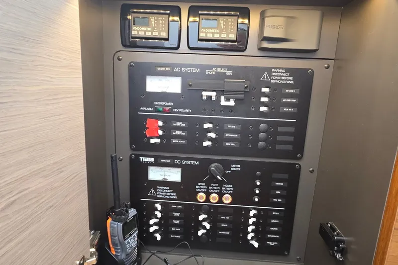 Slide: The Image of Electrical control panel on a 2022 Tiara Yachts 34 LS, featuring AC and DC systems. - 37
