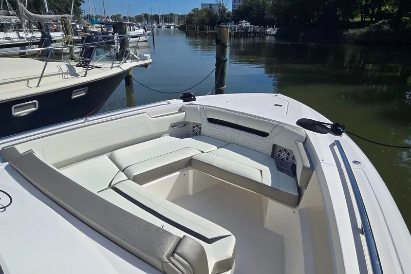 Slide: The Image of 2022 Tiara Yachts 34 LS boat with spacious seating, docked in a serene marina. - 16