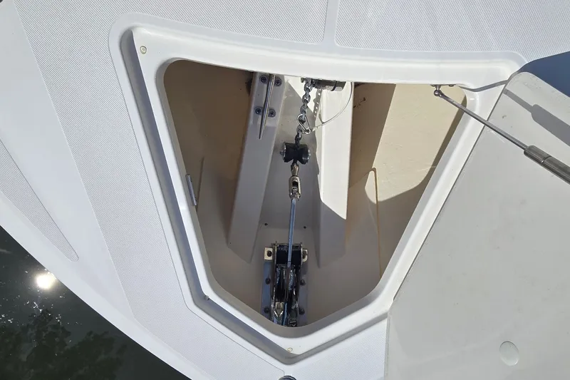 Slide: The Image of Anchor compartment of 2022 Tiara Yachts 34 LS, showcasing chain and mechanism. - 19