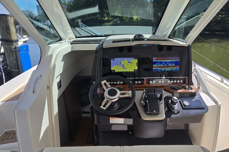 Slide: The Image of 2022 Tiara Yachts 34 LS helm with dual displays and modern controls. - 22