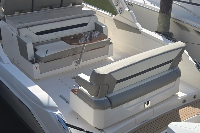 Slide: The Image of 2022 Tiara Yachts 34 LS boat interior with seating and table, showcasing luxury design. - 6