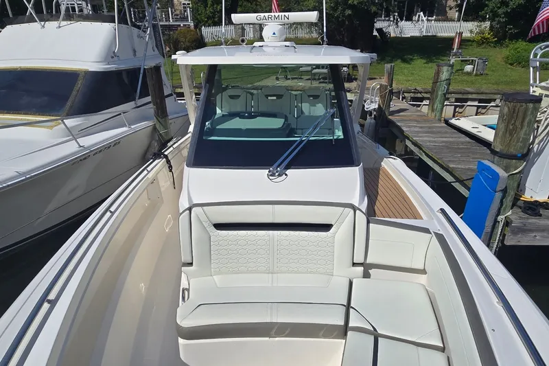 Slide: The Image of 2022 Tiara Yachts 34 LS boat docked, featuring sleek design and comfortable seating. - 17
