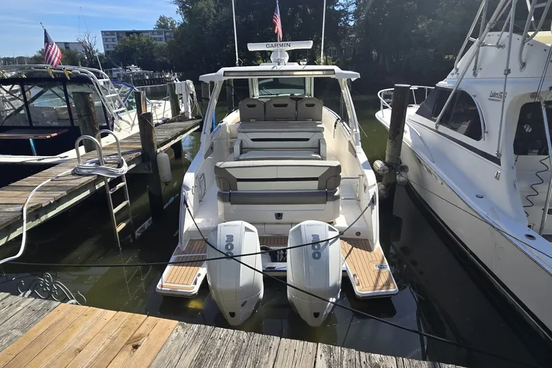 Slide: The Image of 2022 Tiara Yachts 34 LS docked, featuring twin outboard engines and spacious seating. - 1