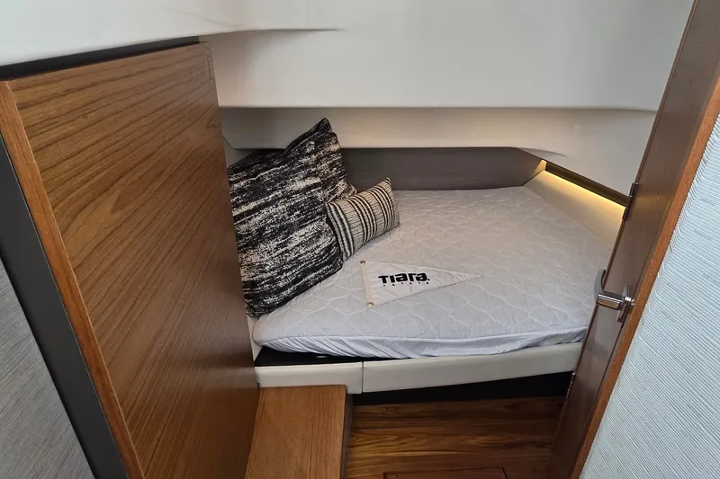 Slide: The Image of Cozy cabin interior of 2022 Tiara Yachts 34 LS with stylish bedding and pillows. - 31