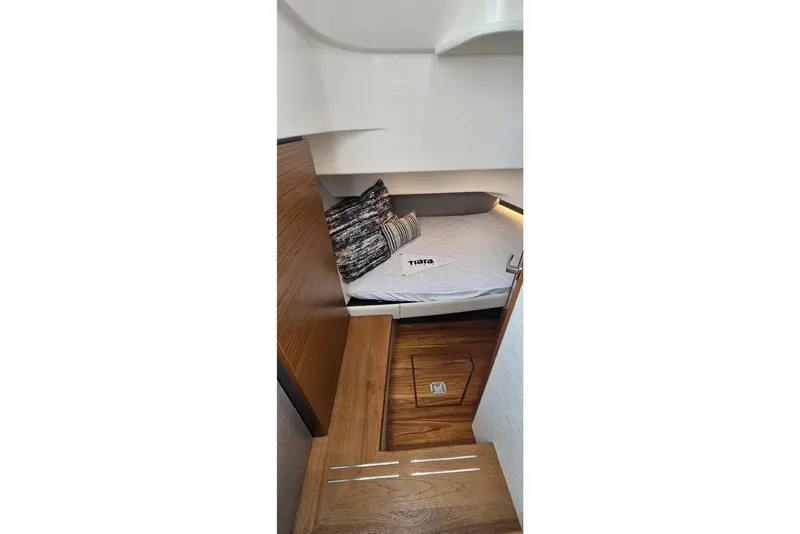 Slide: The Image of Interior cabin of 2022 Tiara Yachts 34 LS with wooden flooring and cozy bedding. - 32