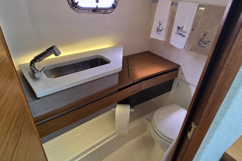 Slide: The Image of Luxurious bathroom in 2022 Tiara Yachts 34 LS, featuring modern sink and elegant wood accents. - 36