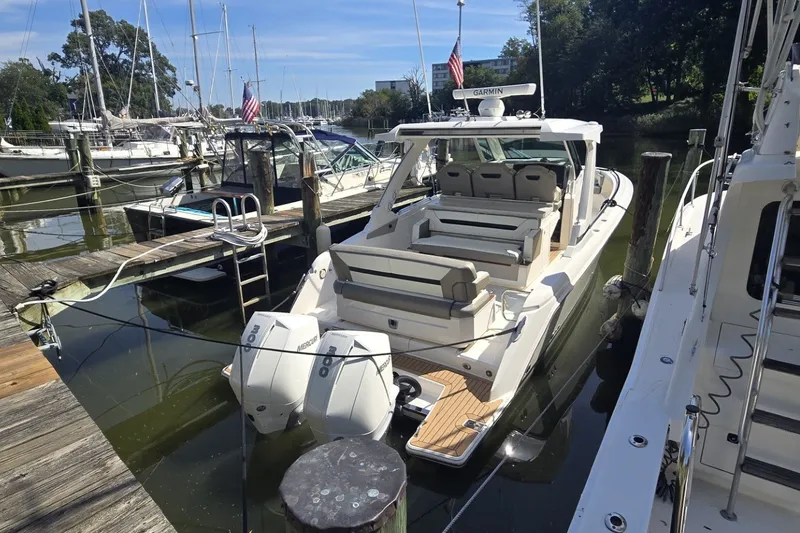 Slide: The Image of 2022 Tiara Yachts 34 LS docked, featuring dual Mercury outboard engines and spacious seating. - 2