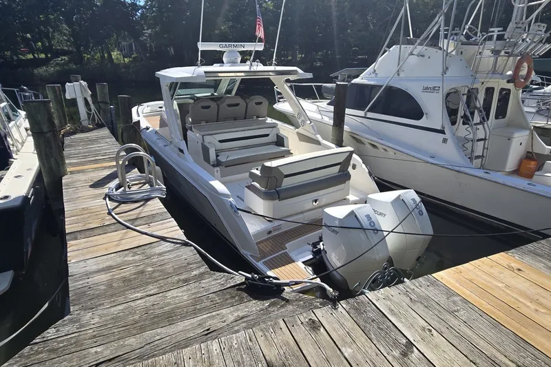 Slide: The Image of 2022 Tiara Yachts 34 LS docked, featuring dual Mercury outboard engines. - 3