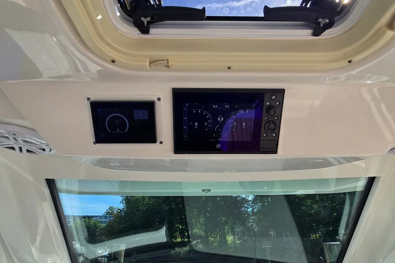Slide: The Image of Dashboard of 2022 Tiara Yachts 34 LS with digital displays and controls. - 23