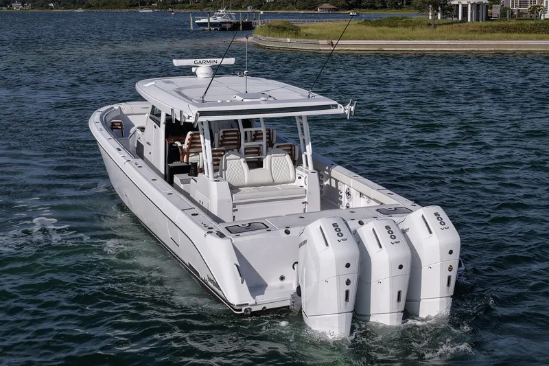 Slide: The Image of 2026 Everglades 455 Center Console boat with triple engines on water. - 14