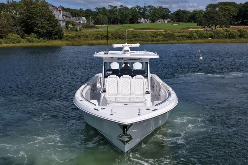 Slide: The Image of 2026 Everglades 455 Center Console boat on serene water, surrounded by lush greenery. - 3