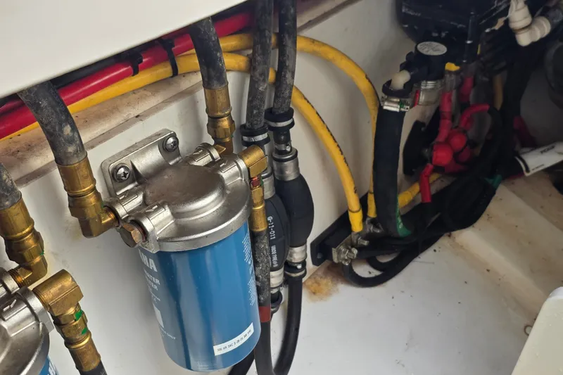 Slide: The Image of Engine compartment of a 2019 Pursuit S 328 Sport boat, showing fuel filter and hoses. - 34