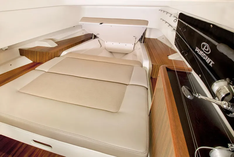 Slide: The Image of Manufacturer Provided Image: 2019 Pursuit S 328 Sport boat interior with cushioned seating and wooden accents. - 38