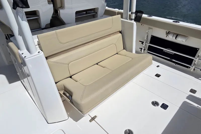 Slide: The Image of 2019 Pursuit S 328 Sport boat interior with beige seating and deck details. - 25