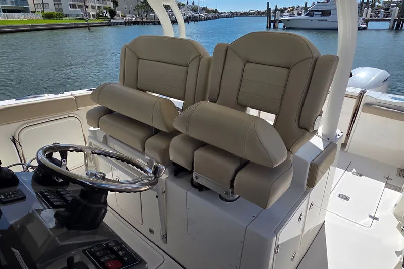 Slide: The Image of 2019 Pursuit S 328 Sport boat interior with dual helm seats and steering wheel. - 13