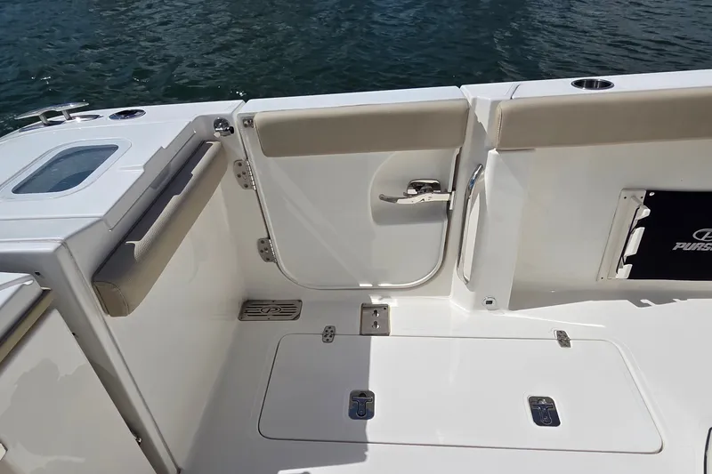 Slide: The Image of 2019 Pursuit S 328 Sport boat deck with seating and storage compartments. - 28