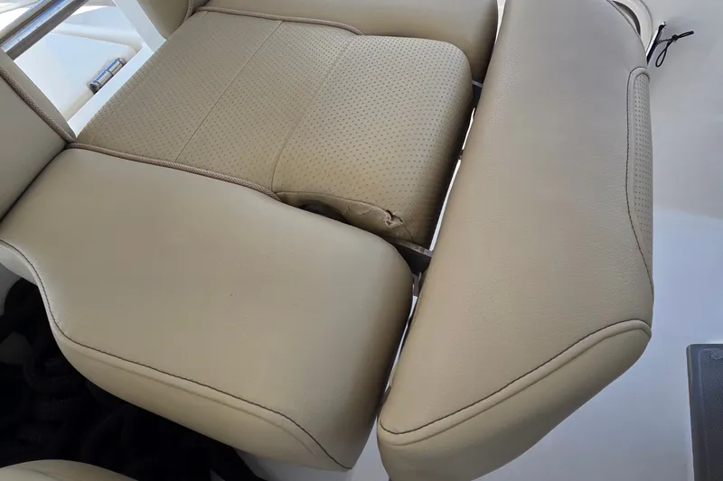 Slide: The Image of Beige leather seating on 2019 Pursuit S 328 Sport boat, showing slight wear. - 31