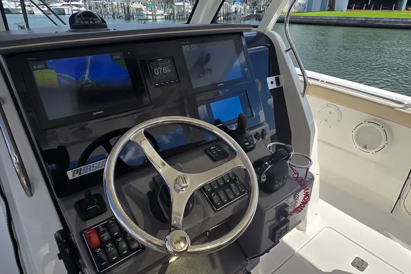 Slide: The Image of 2019 Pursuit S 328 Sport boat helm with advanced navigation displays and controls. - 24