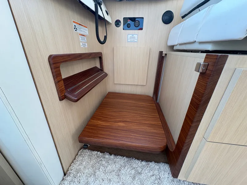 Slide: The Image of Interior of the 2024 Regal 38 Grande Coupe with wood accents and carpeted flooring. - 18
