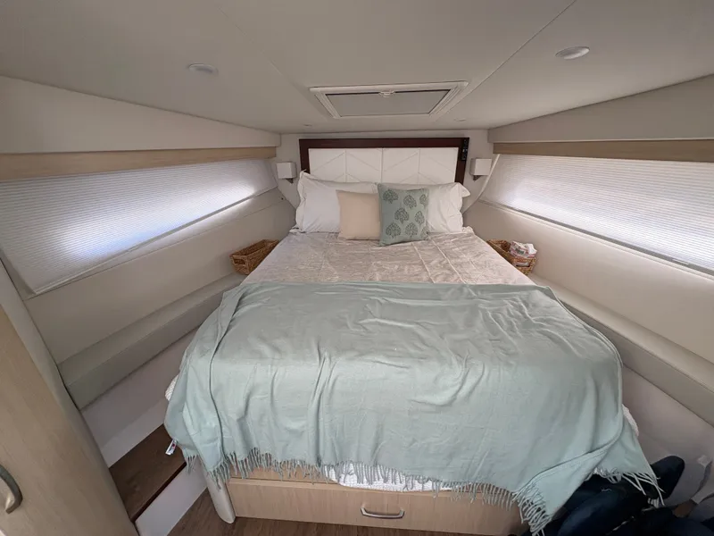 Slide: The Image of The image shows a cozy cabin with a double bed, soft pillows, and a blanket. - 42
