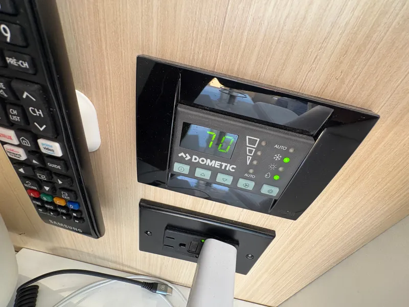 Slide: The Image of Close-up of a Dometic control panel in a 2024 Regal 38 Grande Coupe. - 41