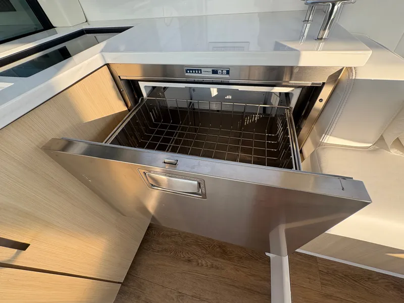 Slide: The Image of Open stainless steel dishwasher in a modern boat kitchen. - 9