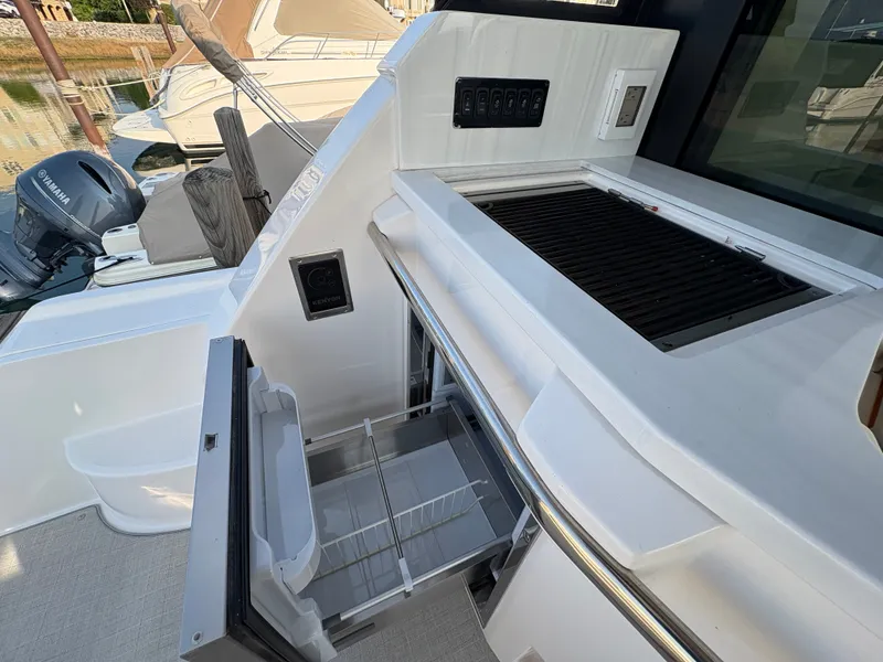 Slide: The Image of The 2024 Regal 38 Grande Coupe features an outdoor kitchen with a grill and refrigerator. - 31