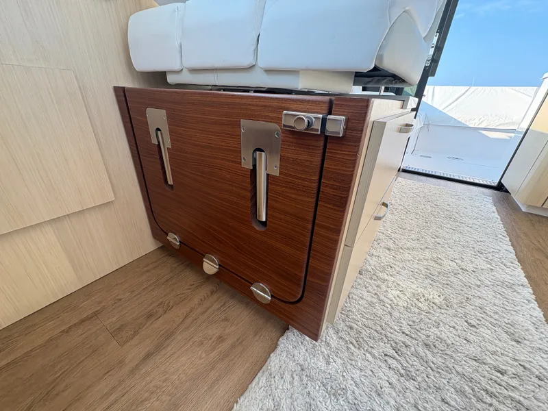 Slide: The Image of Interior of a 2024 Regal 38 Grande Coupe with wood flooring and white seating. - 19
