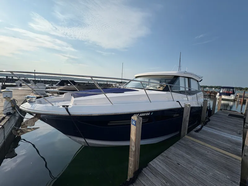 Slide: The Image of The 2024 Regal 38 Grande Coupe is docked. It features a sleek, modern design. - 2