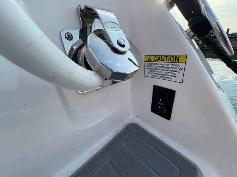 Slide: The Image of Close-up of a boat deck with stainless steel fittings and a caution sign. Water is visible in the background. - 35
