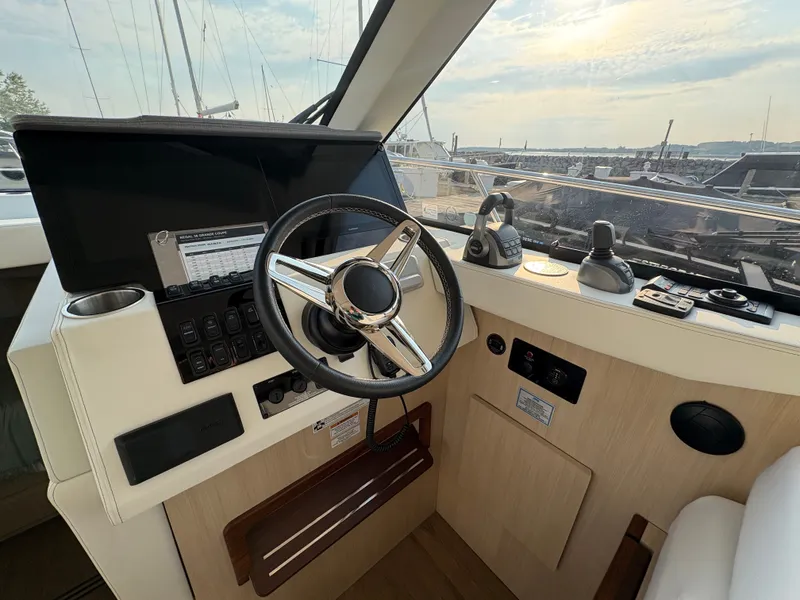 Slide: The Image of The cockpit of the 2024 Regal 38 Grande Coupe features a modern steering wheel with instruments and a display. - 15