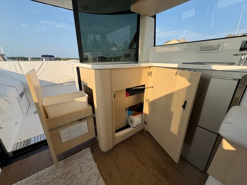 Slide: The Image of The 2024 Regal 38 Grande Coupe features a modern interior with wooden cabinets and a carpeted floor. - 8