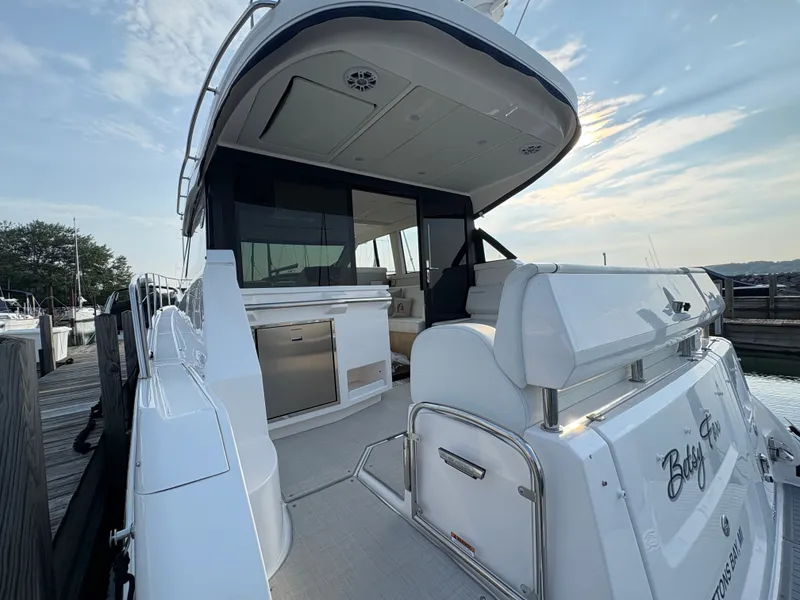 Slide: The Image of The 2024 Regal 38 Grande Coupe features a sleek design with a spacious aft deck. - 37
