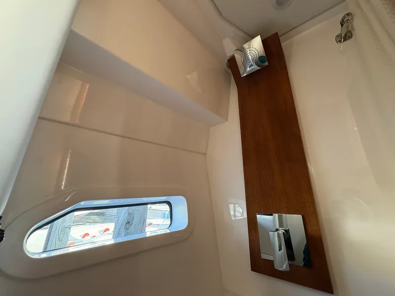 Slide: The Image of Interior view of a modern boat cabin with wood paneling and a window. - 48