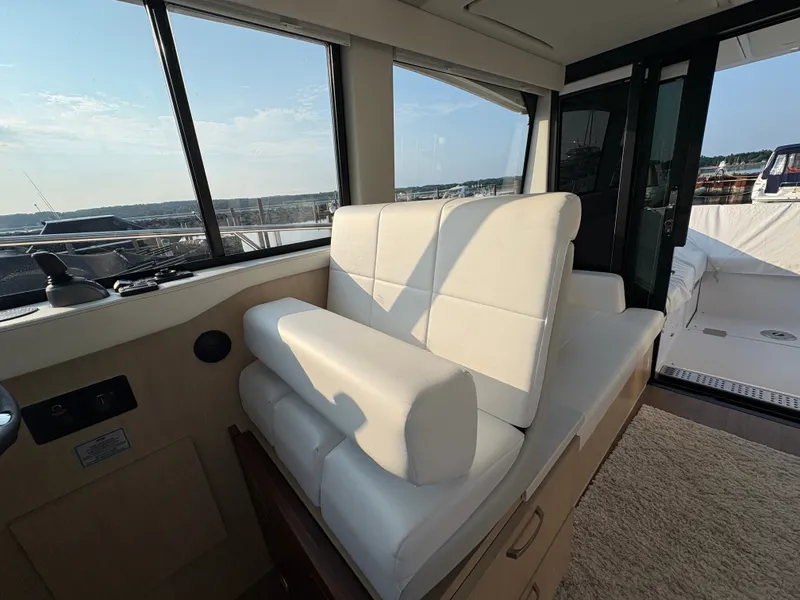 Slide: The Image of Interior of a 2024 Regal 38 Grande Coupe with white leather seating and large windows. - 16