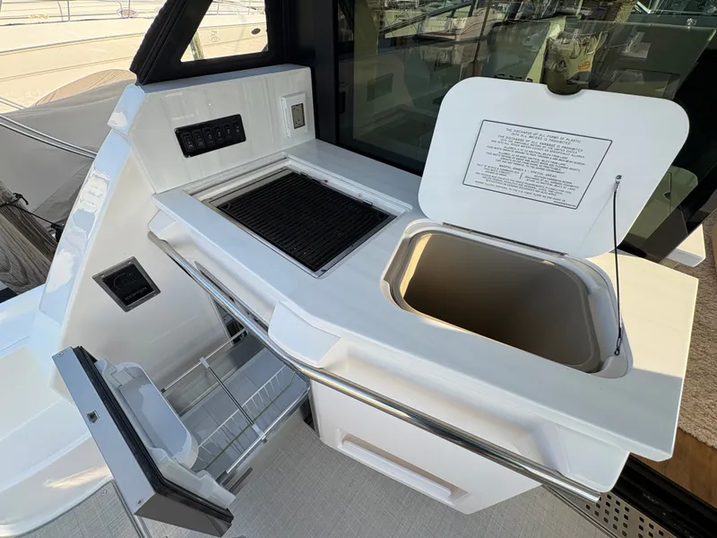 Slide: The Image of The 2024 Regal 38 Grande Coupe features an outdoor kitchen with a grill and sink. - 30