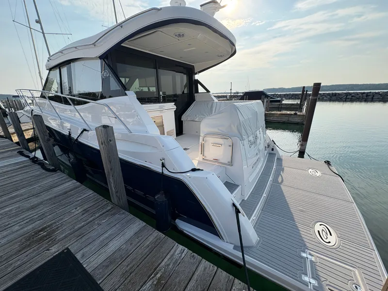 Slide: The Image of The 2024 Regal 38 Grande Coupe is docked. It features a sleek design and spacious deck area. - 4