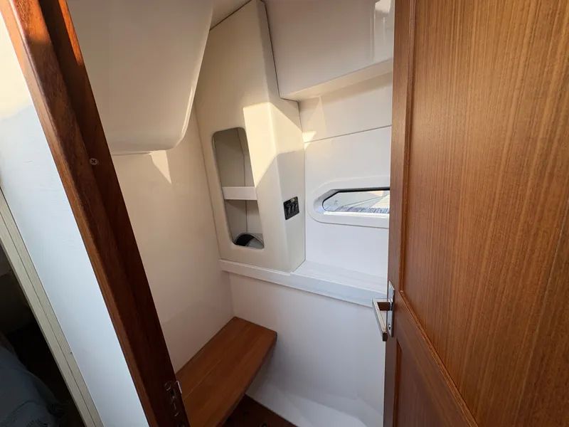 Slide: The Image of Interior of a 2024 Regal 38 Grande Coupe with a wooden door and bench. - 47