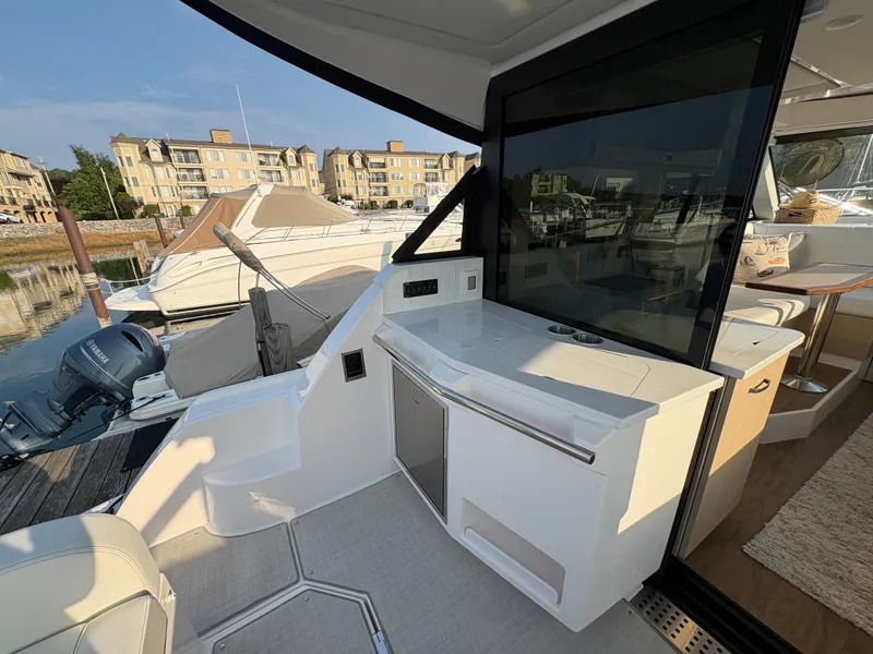 Slide: The Image of The 2024 Regal 38 Grande Coupe features a modern outdoor kitchen with a sink and storage. - 29