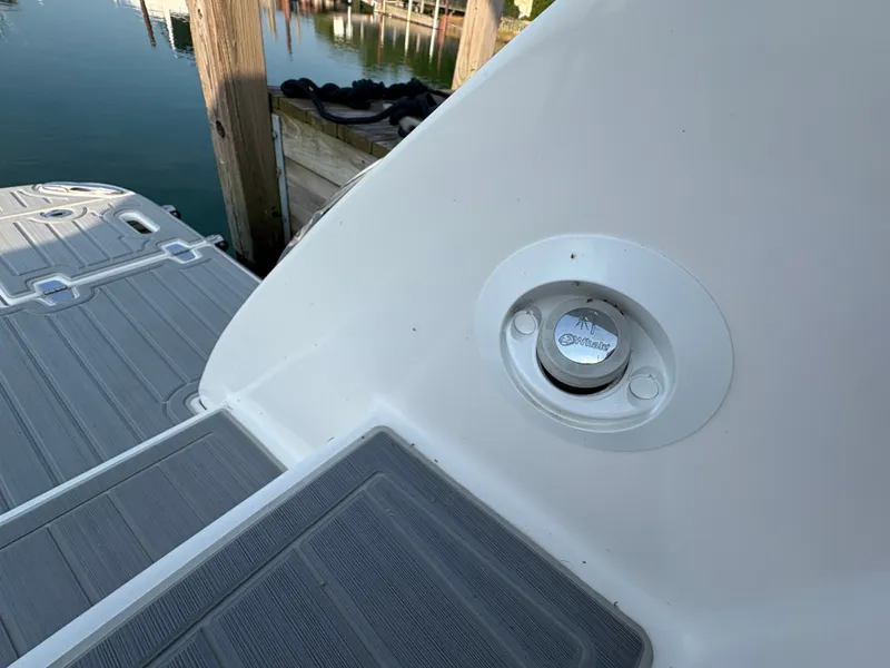 Slide: The Image of The image shows the stern of a boat with gray decking and a round fitting. - 33