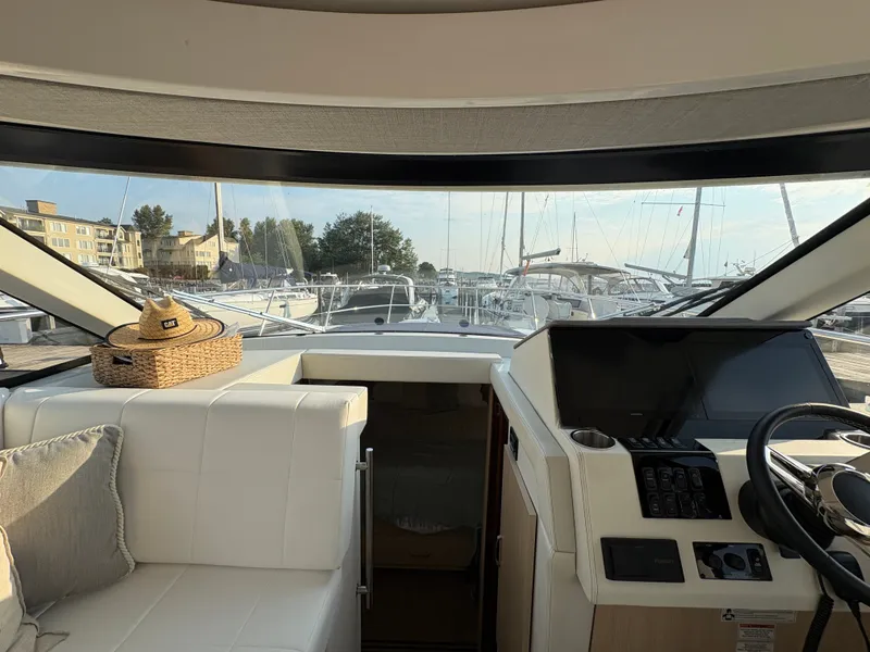 Slide: The Image of The cockpit of the 2024 Regal 38 Grande Coupe features luxurious seating and modern controls. - 25