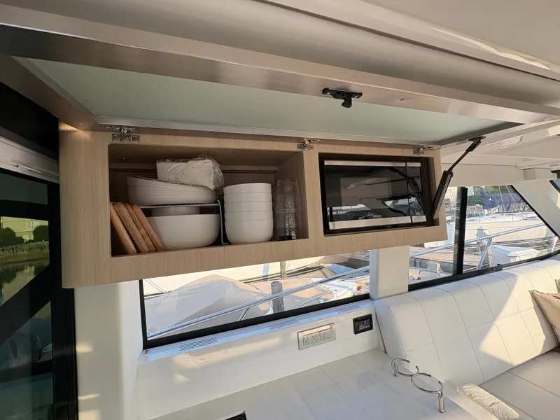 Slide: The Image of The 2024 Regal 38 Grande Coupe features a sleek interior with modern cabinets and dishware. - 11
