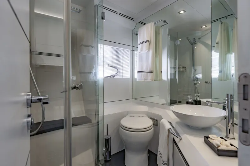 Slide: The Image of Luxurious bathroom in a 2010 Pershing 80 yacht, featuring modern fixtures and elegant design. - 72